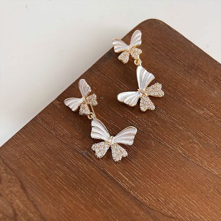 Detailed view of the double butterfly earrings with rhinestone details.