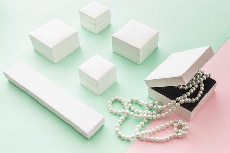 Customizable white jewelry boxes with pearl accents for premium corporate gifts.
