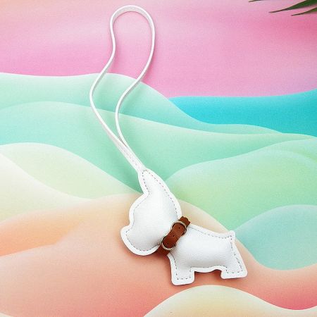 A white leather French Bulldog charm against a colorful, playful background.
