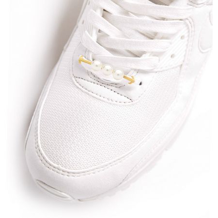 Triple pearl shoe tag elegantly displayed on a white sneaker's laces.
