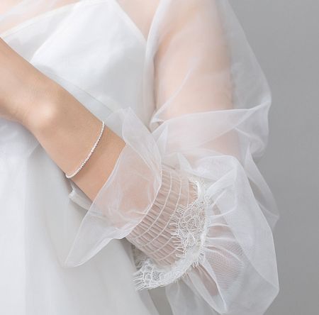 Side view of the sterling silver glittering bracelet on a woman's arm.