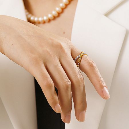 Elegant styling of the crisscross ring set with a pearl necklace.