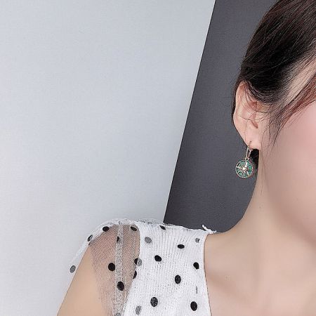 Model wearing the Palace Green Vintage Art Deco Earrings to show scale and style.