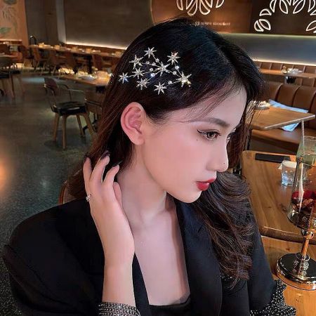 A woman models the star-shaped hair clip, adding a fashionable touch to her look.