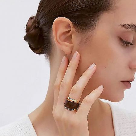 A stylish look featuring the chunky brass and brown enamel ring, highlighting its bold design.
