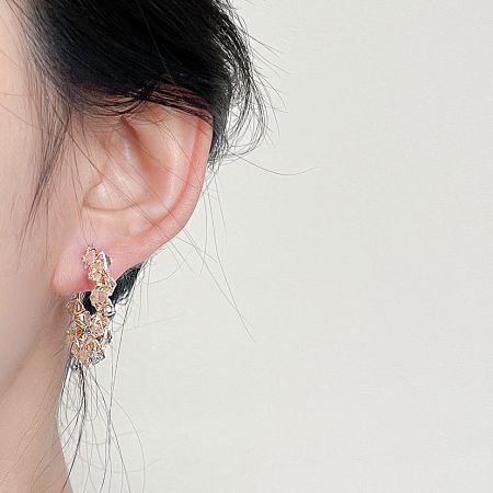 A model wearing the elegant gold-plated crystal zircon hoop earring to showcase its size and sparkle.