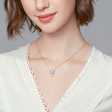 Model wearing a celestial-themed necklace, showcasing its length and style.