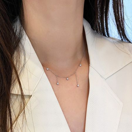Model wearing the gold-finished 925 sterling silver zircon charm necklace.