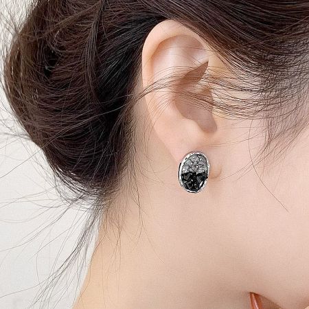 Side profile of a model wearing the silver earring, showing its scale and sparkle.