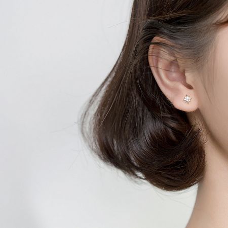Model wearing the silver CZ mini starburst stud earring.