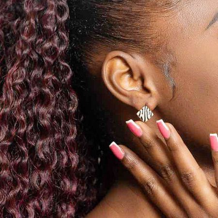 Model wearing the 925 sterling silver zebra pattern stud earring to show scale and style.