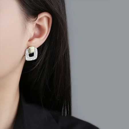 925 Sterling Silver Two-Tone Geometric Hollow Square Stud Earrings (5 pairs) - A close-up of a woman wearing the 925 sterling silver two-tone geometric hollow square stud earring, highlighting its elegant design.