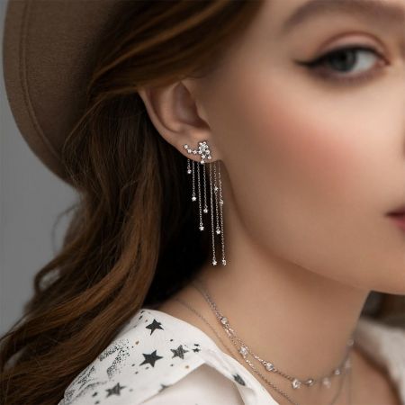 Model showcasing the elegant 925 sterling silver CZ star tassel drop earrings with matching necklaces.