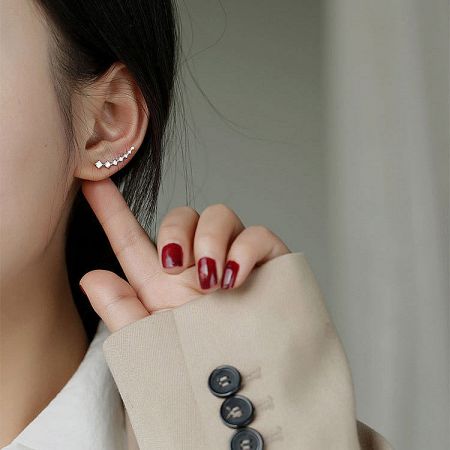 Side profile of a model showcasing the unique design of the silver climber earring.