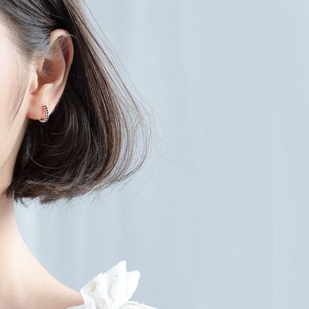 Model showcasing the elegant 925 Sterling Silver Hoop Earrings with Zirconia.