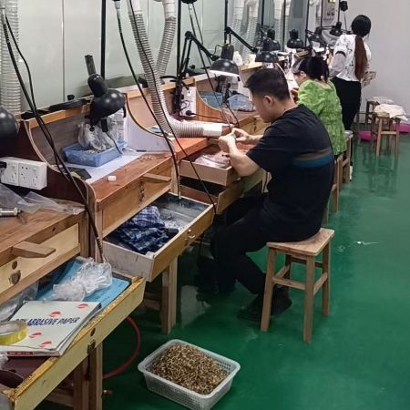 Skilled artisans at JR Fashion Accessories meticulously crafting custom jewelry components in the workshop.