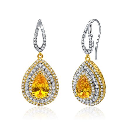 Close-up shot of the yellow gemstone teardrop earring, showcasing the central stone surrounded by sparkling cubic zirconia accents.