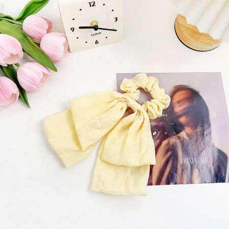 The vibrant yellow scrunchie shown with matching fabric.