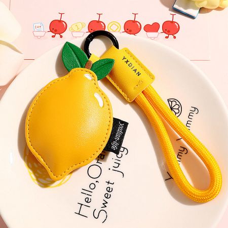 Sunny yellow lemon-shaped PU leather keychain, a cheerful accessory for bags.