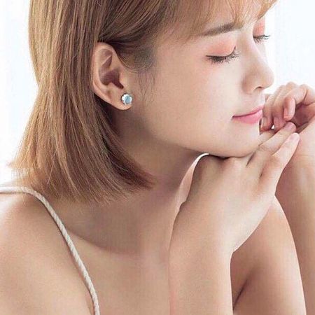 Model wearing the elegant asymmetrical moonstone mermaid stud earring.