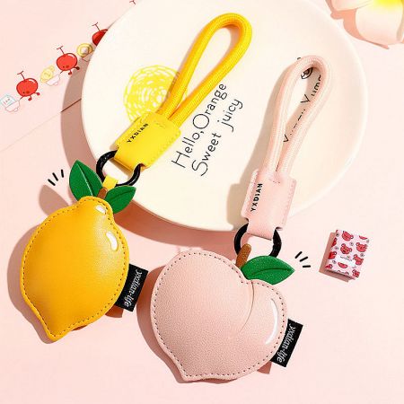 Creative PU Leather Fruit Keychain — Peach, Lemon & Cherry Bag Charm (5 pcs) - A pair of cute PU leather fruit keychain charms, one shaped like a yellow lemon and the other a pink peach, perfect as bag accessories.