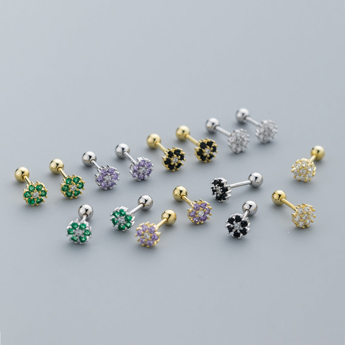 A vibrant collection of 925 sterling silver flower stud earrings, showcasing various colorful cubic zirconia options in both silver and gold finishes.