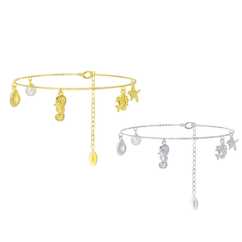 A pair of 925 sterling silver ocean-themed charm bracelets, one in a gold finish and one in a silver finish, displayed side-by-side.