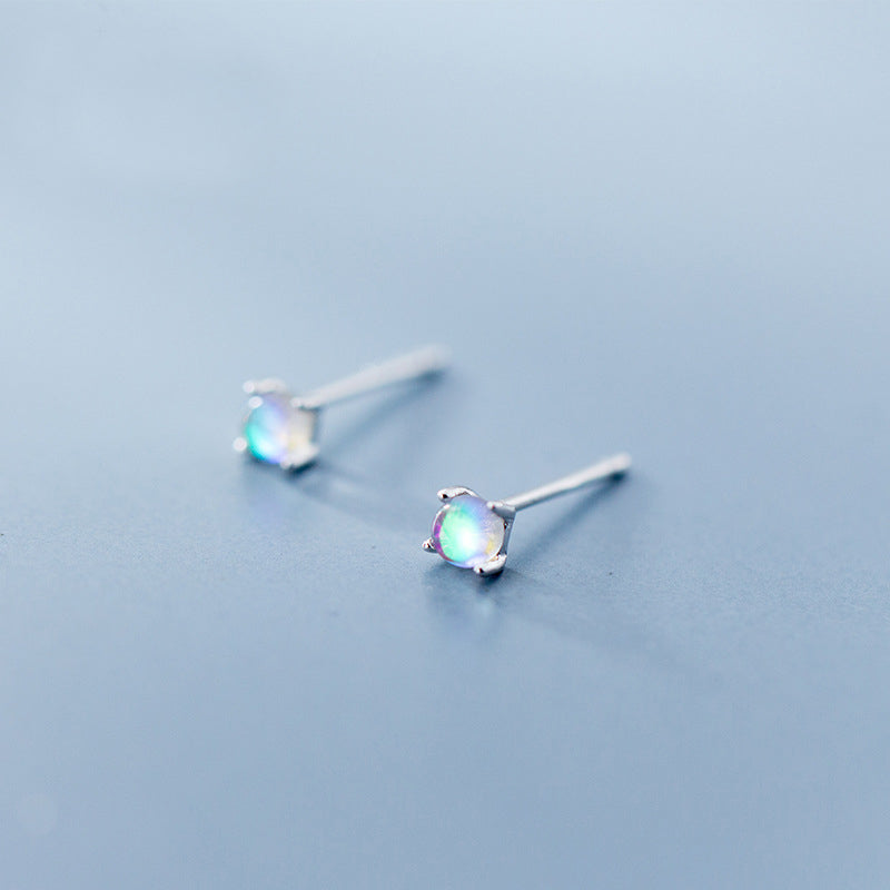 A close-up studio shot of the 925 sterling silver mini rainbow moonstone stud earrings, showcasing their iridescent quality.