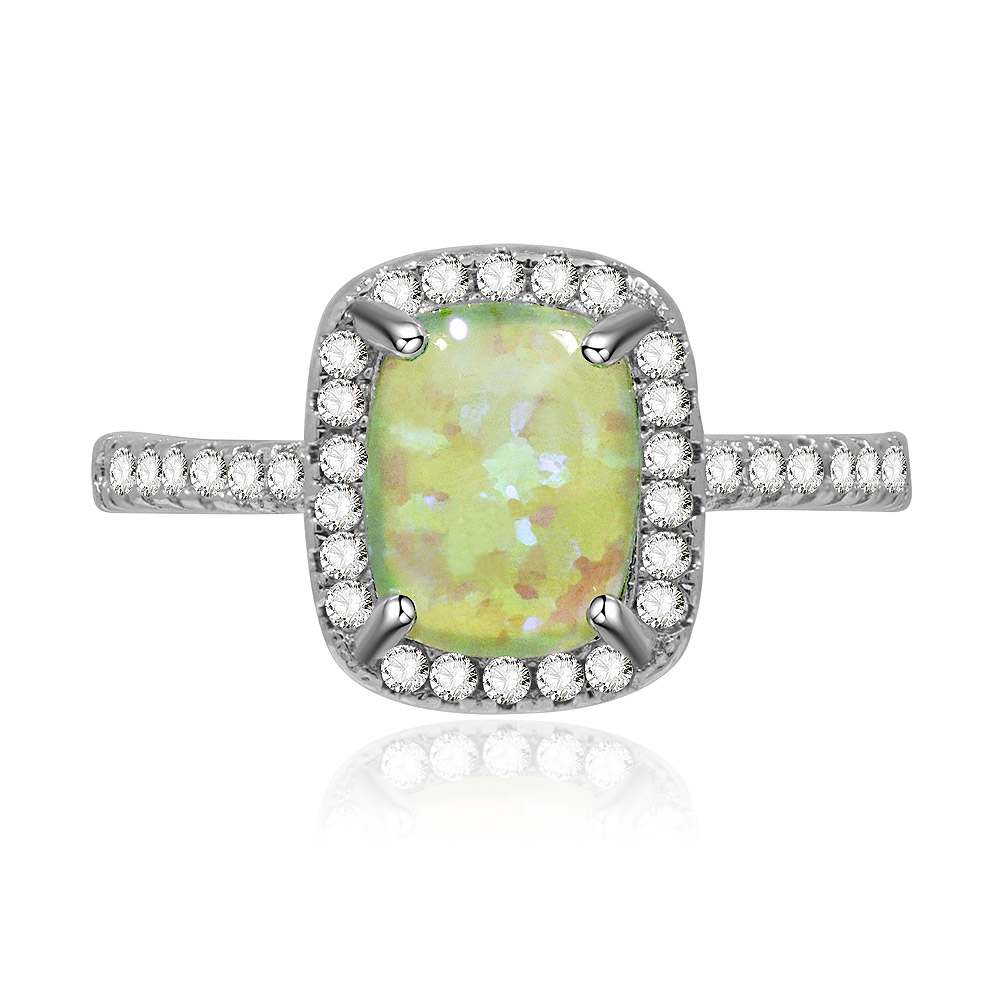 A close-up of the Green Opal Burst White Ring, showcasing the square-cut green opal glass surrounded by a halo of sparkling white cubic zirconia, set on a rhodium-plated brass band.