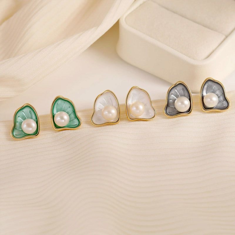 A collection of 14k gold-plated enamel scallop pearl stud earrings in various colors, displayed on a neutral background.