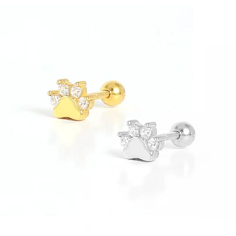 A pair of 925 sterling silver mini paw print stud earrings, one in a silver finish and one in a gold finish, both intricately set with sparkling cubic zirconia stones on a clean white background.