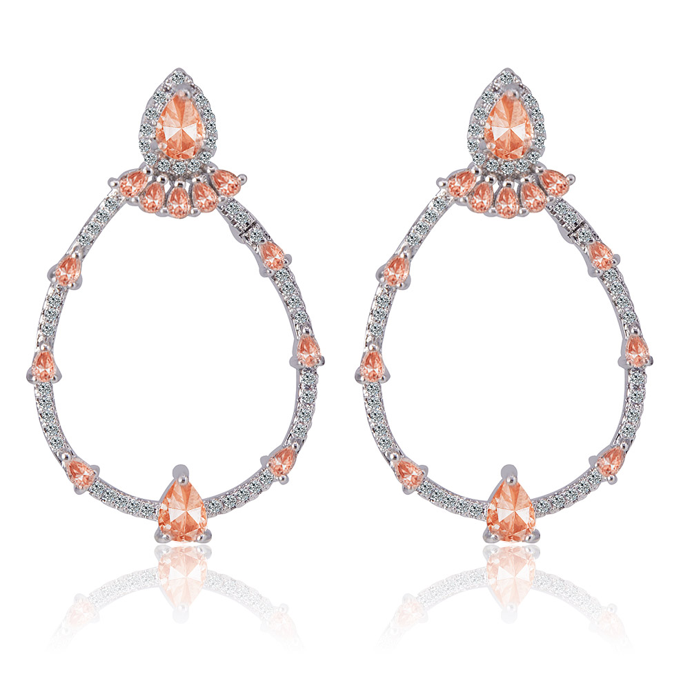 Front view of the Tears O Joy Earring, showcasing the elegant teardrop design with peach gemstones and sparkling cubic zirconia on a rhodium-plated hoop.