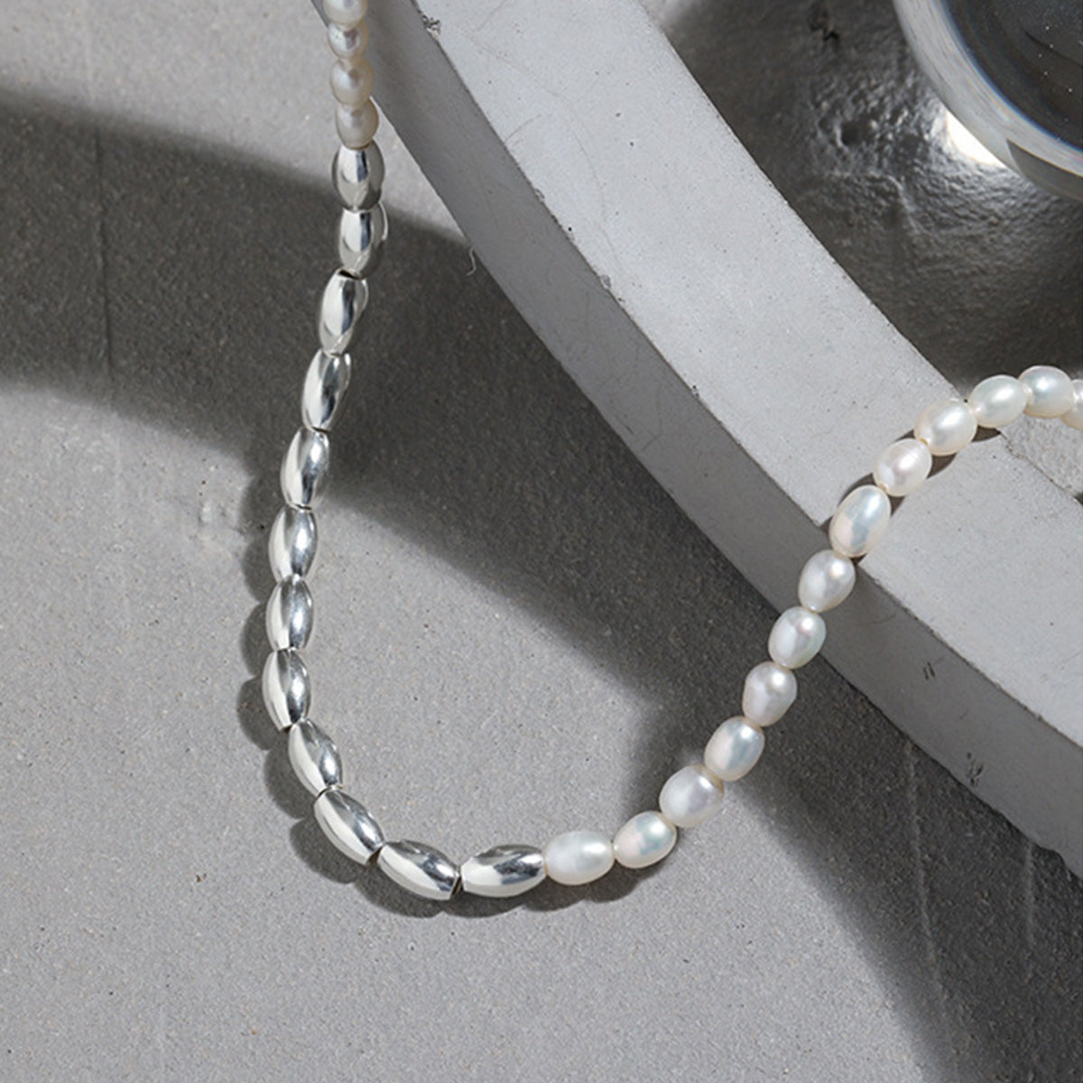 Close-up of a 925 sterling silver necklace with natural freshwater rice pearls, part of a wholesale set.