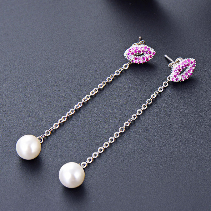 A pair of 925 sterling silver long tassel earrings with a white pearl drop and a stud adorned with pink and white stones.