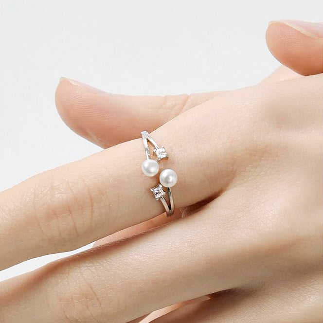 A close-up of the 925 sterling silver open ring featuring two lustrous pearls and sparkling cubic zirconia stones.