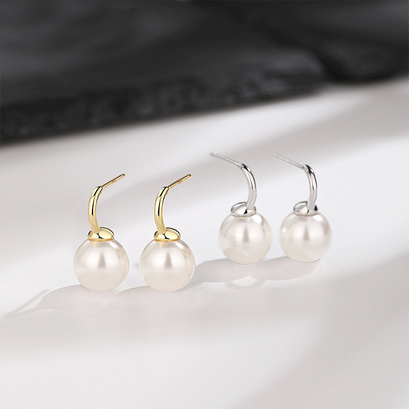 A pair of 925 sterling silver single pearl C-hook earrings shown in both elegant silver and classic gold finishes.