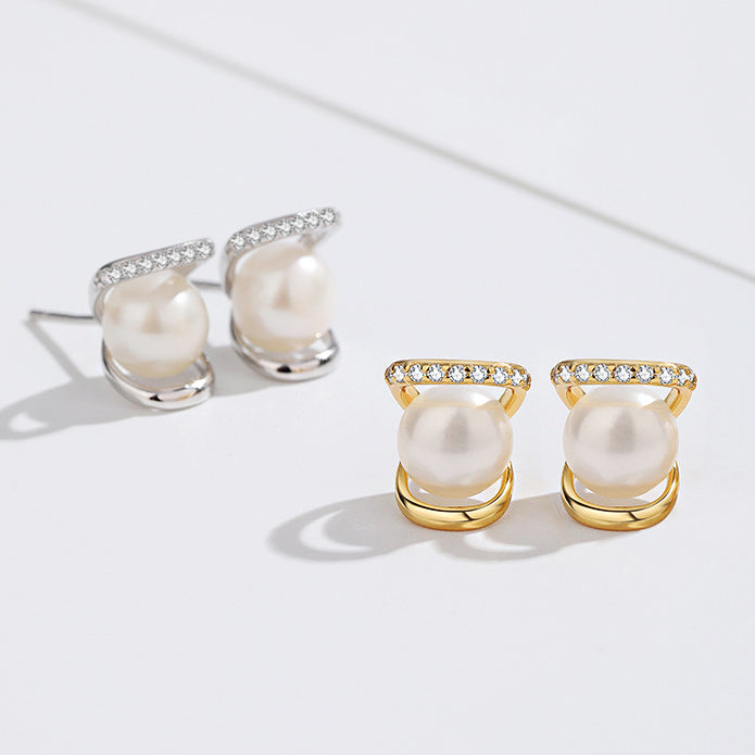 A pair of 925 sterling silver pearl stud earrings and a gold-plated version, each with a single pearl and a small CZ stone accent, displayed on a white background.