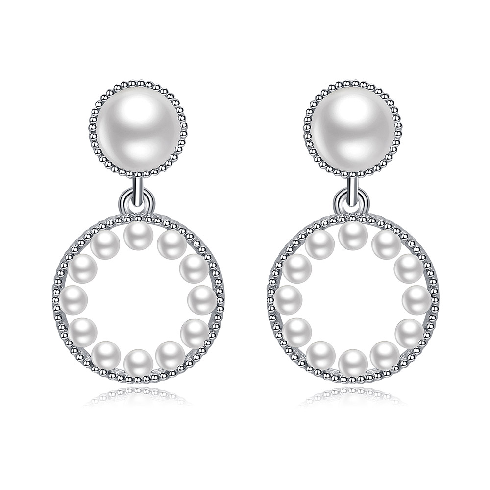Close-up of Pearly Baby Earrings, showcasing the rhodium-plated brass setting with white cubic zirconia and elegant plastic pearls.