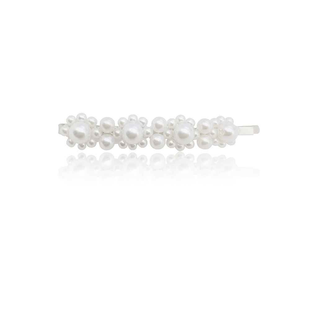 A close-up of the Large Pearl Bobby Pin, showcasing its lustrous simulated pearls arranged on a gold-plated pin.