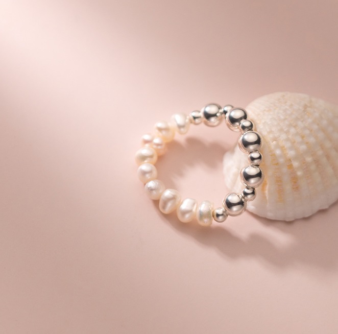 A close-up view of the 925 Sterling Silver Fresh Water Pearl Elastic Bead Ring, showcasing its lustrous pearls and silver bead details.