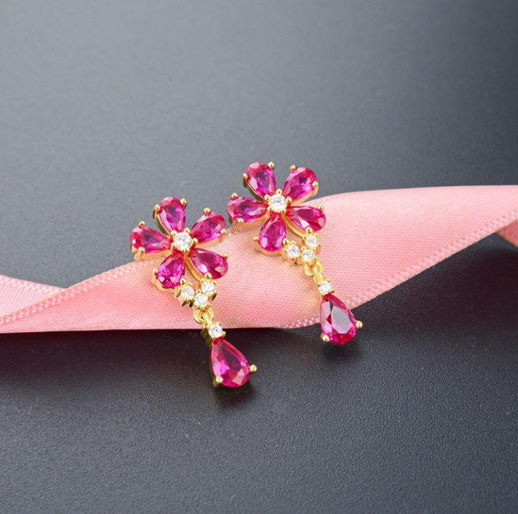 A pair of 925 Sterling Silver Dainty Flower Earrings with gold plating, featuring flower-shaped tops with pink and white cubic zirconia stones and dangling teardrop-shaped pink gemstones.