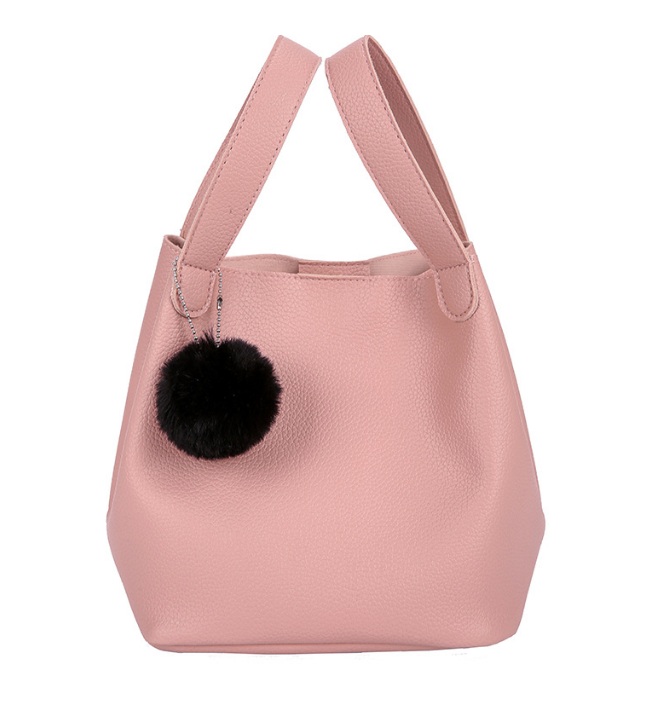 A stylish pink PU leather mini tote bag from JR Fashion Accessories, featuring a chic black pom-pom keychain, showcasing custom handbag options.