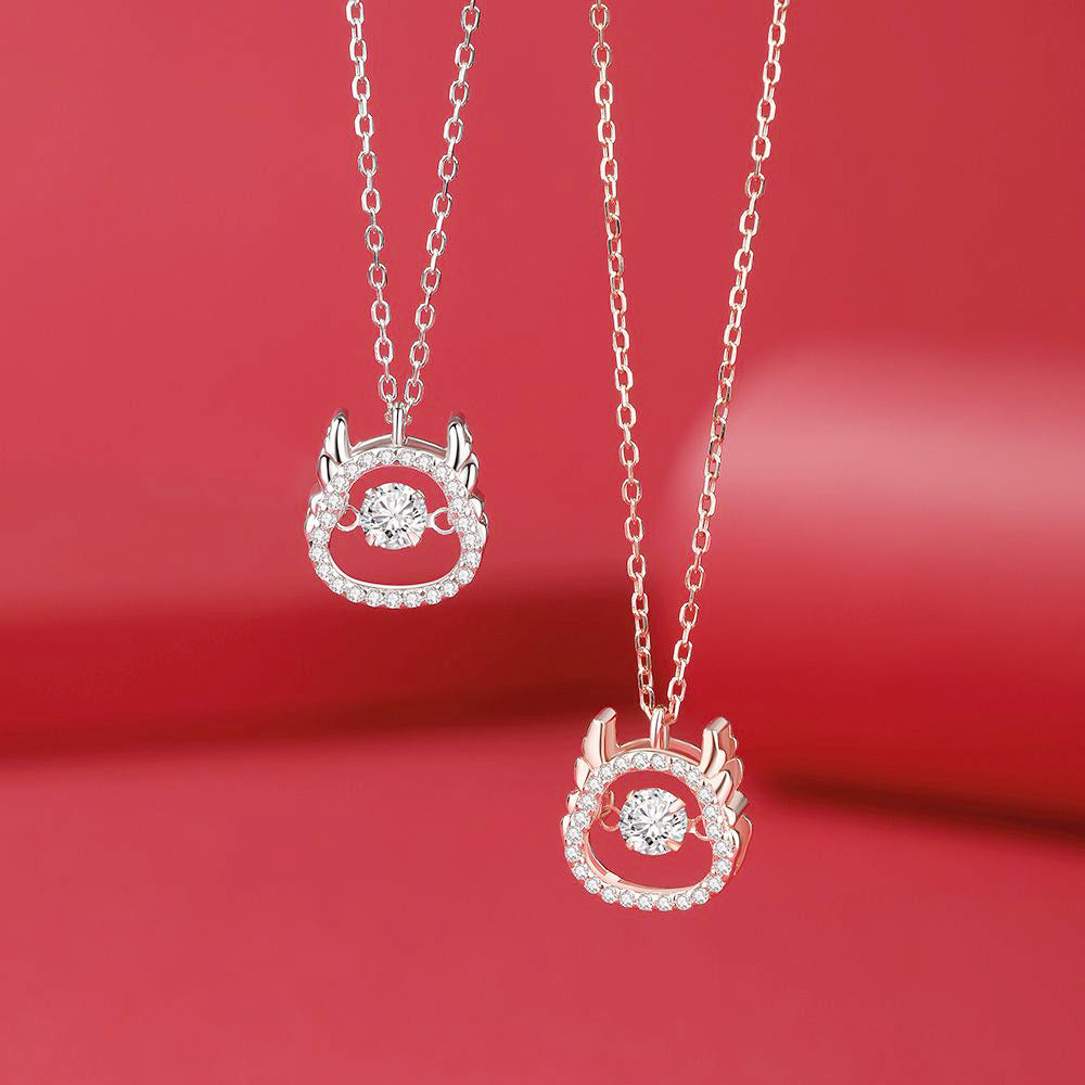 A set of Year of the Dragon pendant necklaces in 925 sterling silver, showcasing both the silver and rose gold color options with central spinning CZ stones.