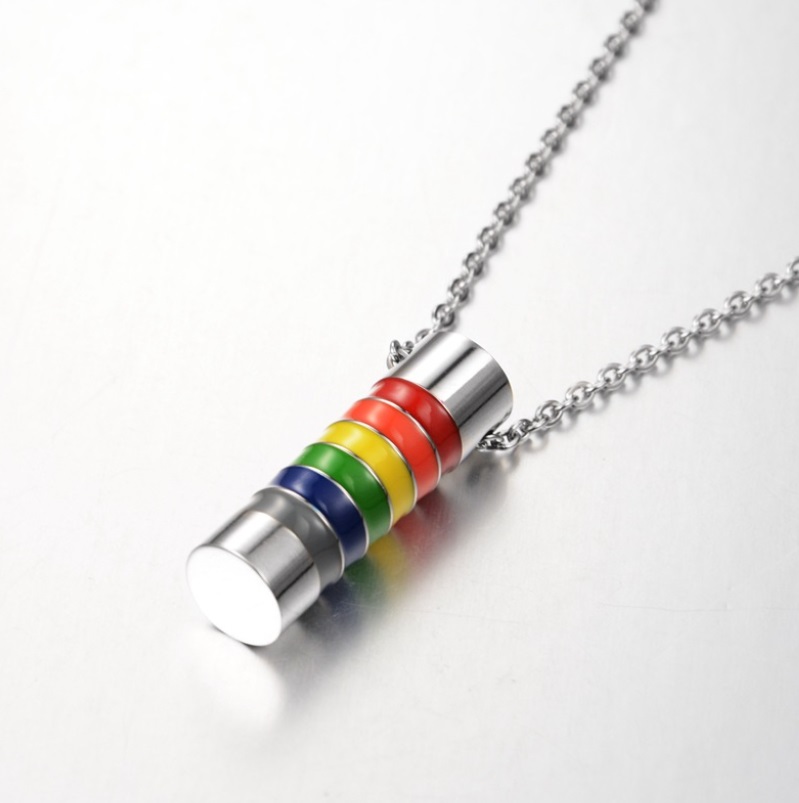 A close-up of the LGBT Pride Rainbow Cylinder Necklace, showing the vibrant enamel colors on the stainless steel pendant and the polished silver chain.