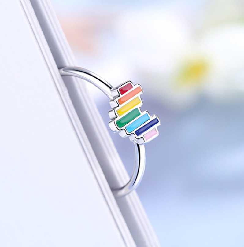 A close-up of the Rainbow Heart Ring in 925 sterling silver, featuring a vibrant multi-color enamel heart design.