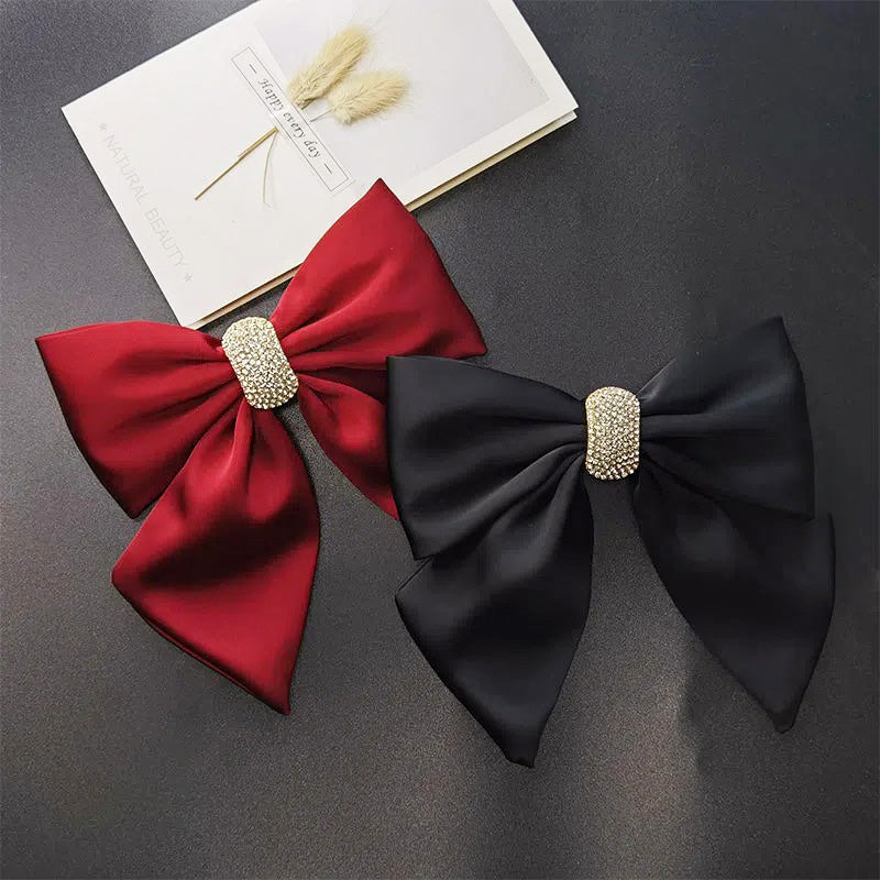 Wholesale set of red and black fabric bowknot hairpin clips, each adorned with a beautiful gold rhinestone embellishment. A perfect fashion accessory for any occasion.