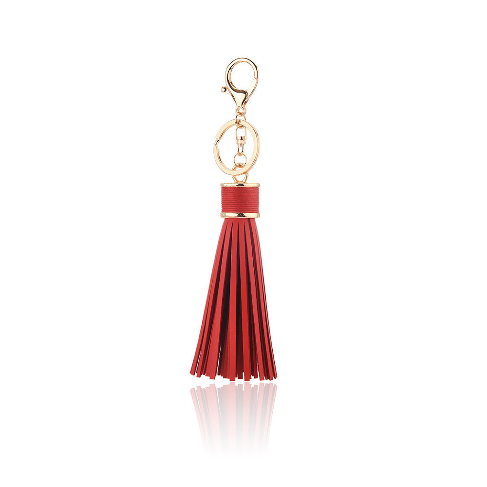 A vibrant red PU leather tassel key chain with polished gold hardware, showcasing its use as a stylish fashion accessory and bag charm.