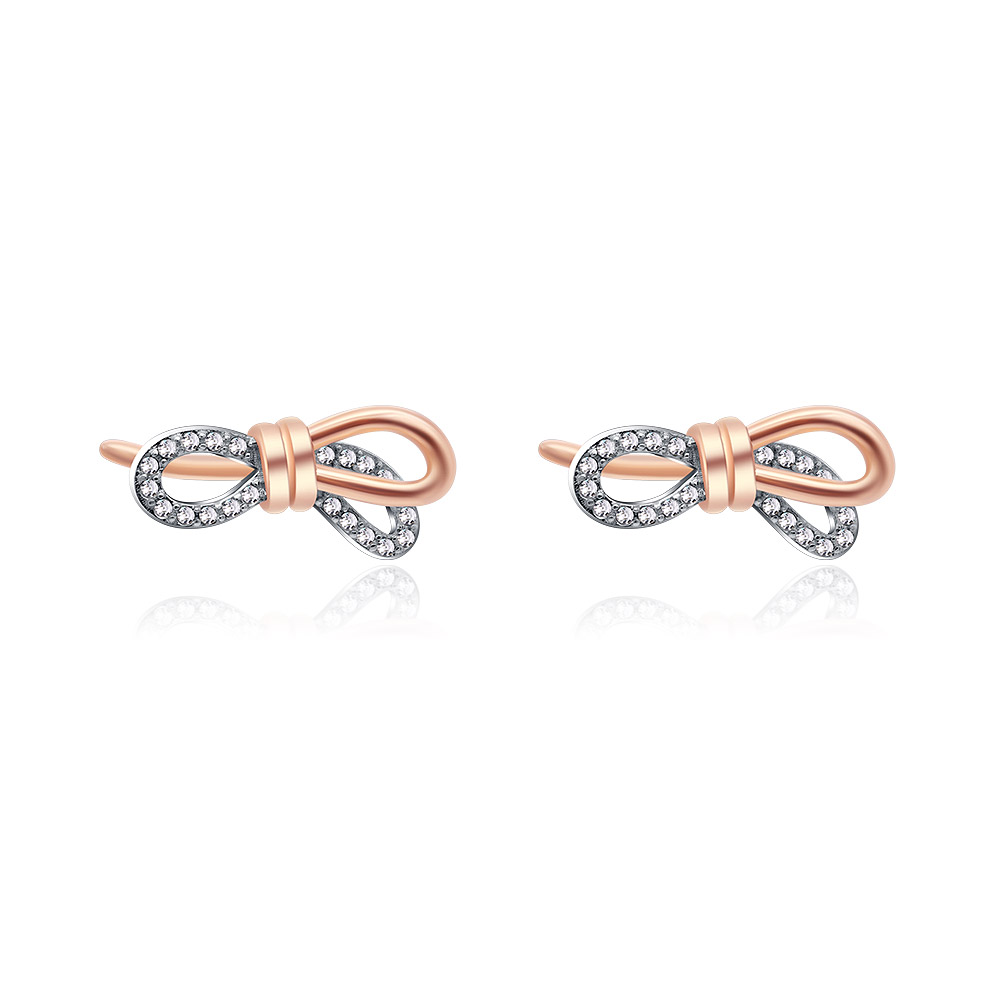 A close-up of the Tied Ribbon Bow Earrings, showcasing the two-tone rose gold and rhodium plating and the sparkling cubic zirconia stones.