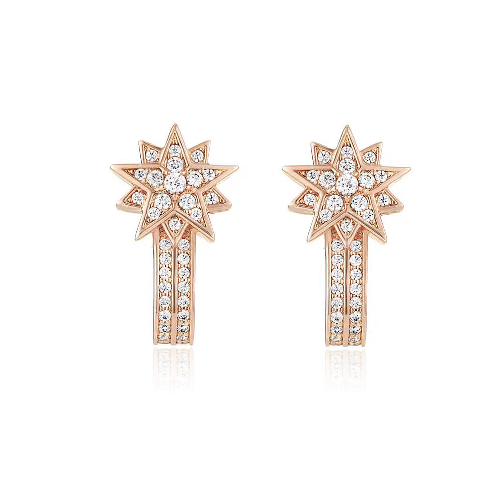 A close-up of the Starburst Long Drop Earrings in rose gold, showcasing the intricate star design studded with sparkling cubic zirconia diamonds.