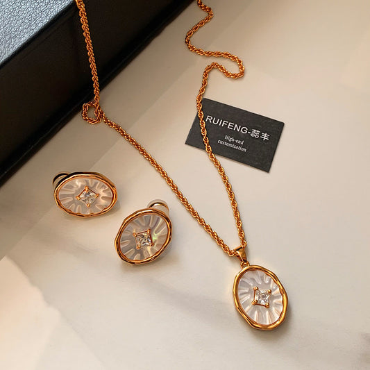 A beautiful rose gold plated brass jewelry set from JR Fashion Accessories, featuring a pendant necklace and matching earrings with elegant mother of pearl inlays.